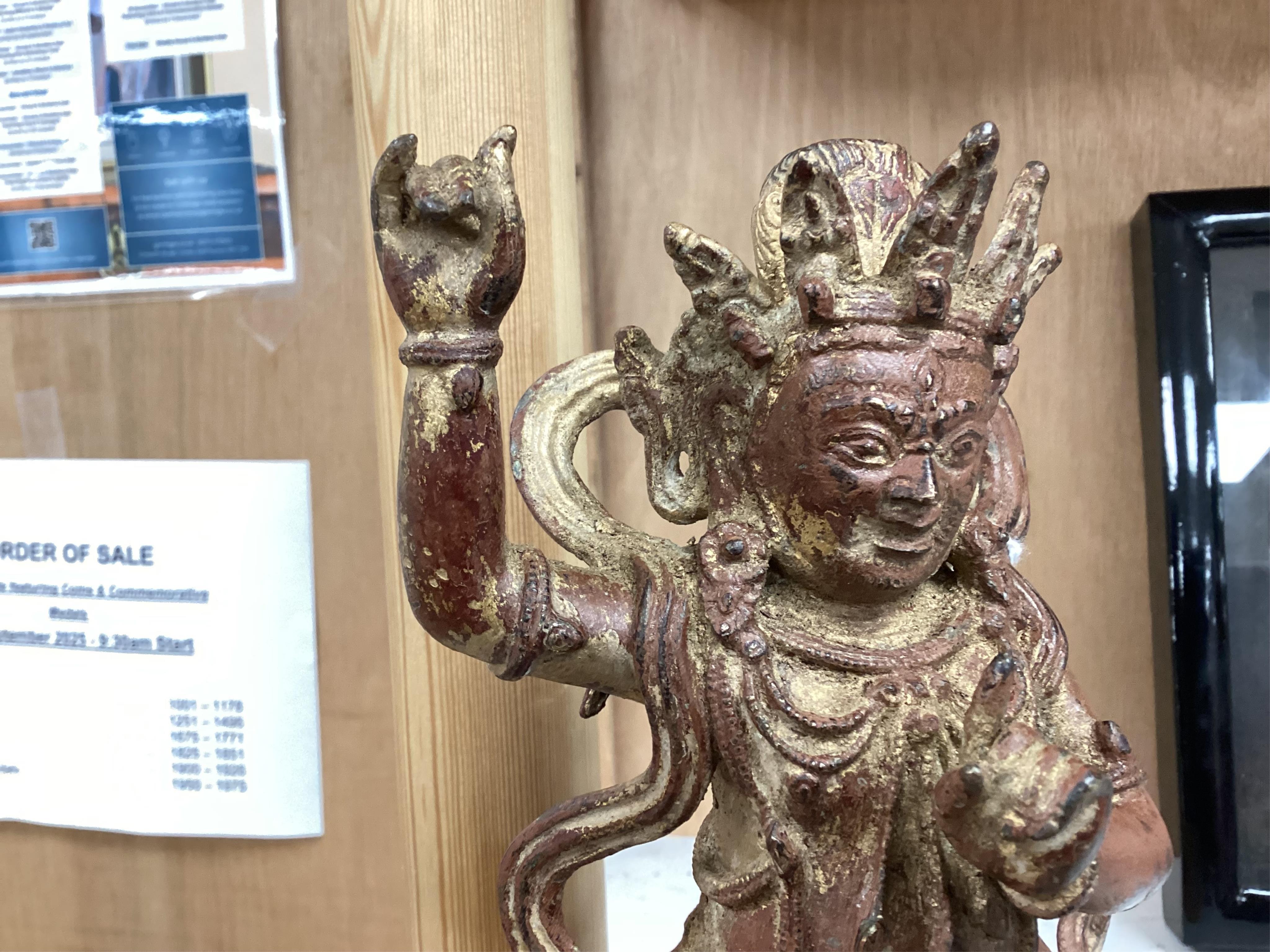 A Buddhist gilt bronze figure of Vaishravana, possibly Tibetan, 21 cm including wooden stand.